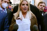 Former Florida Attorney General Pam Bondi displays a court order at the Pennsylvania Convention Centre.