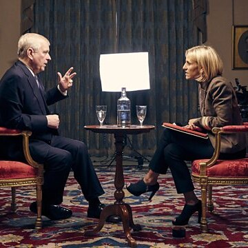 Prince Andrew sits on a chair opposite Emily Maitlis with a film crew in the background.