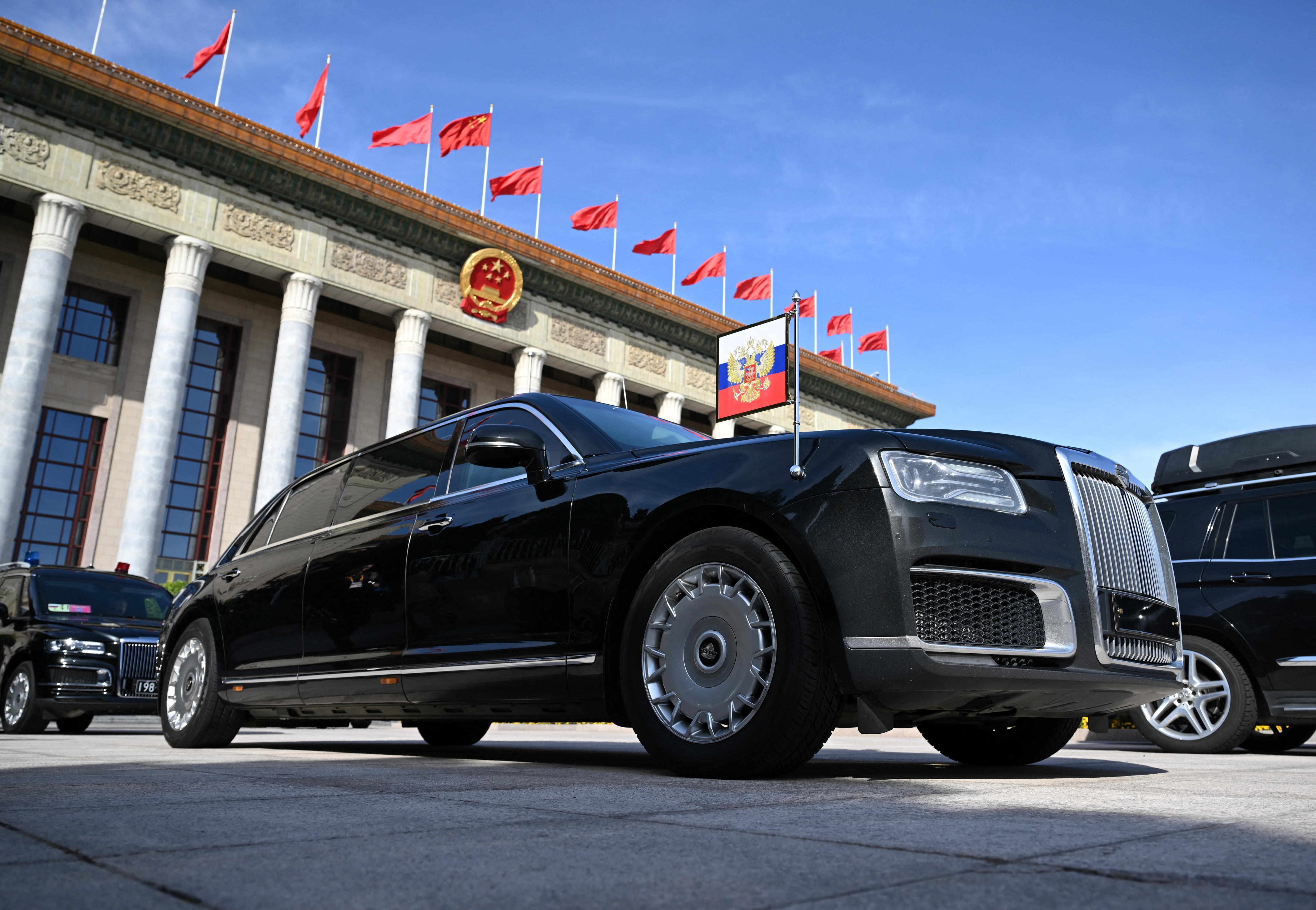 a black limousine in front of China's Great Hall of the People.