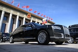 a black limousine in front of China's Great Hall of the People.