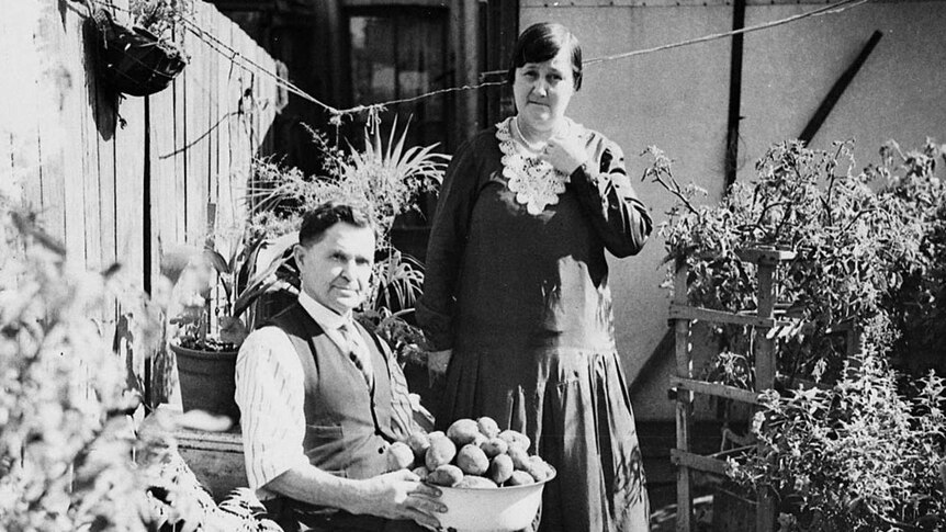 A couple pose in their vegetable garden in the 1930s.