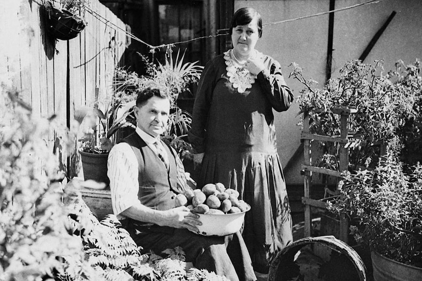 A couple pose in their vegetable garden in the 1930s.