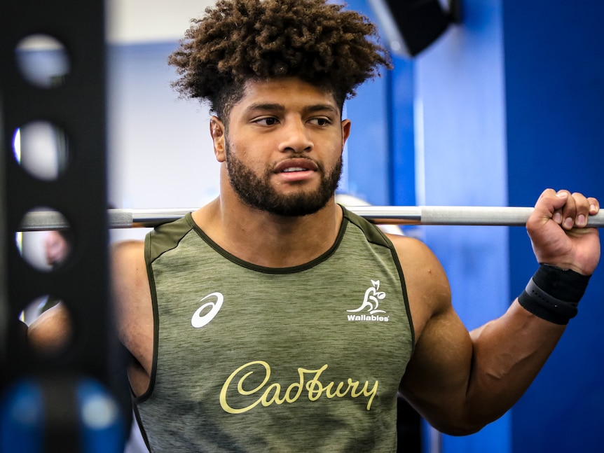 Wallabies player in training gear pumping iron