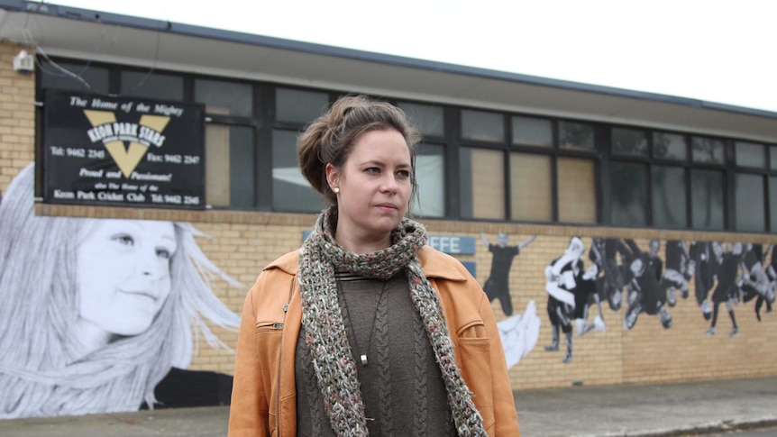 Kirrily Anderson in front of a mural wall