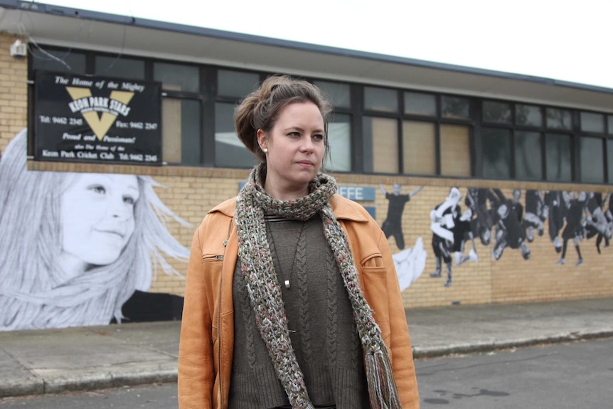 Kirrily Anderson in front of a mural wall