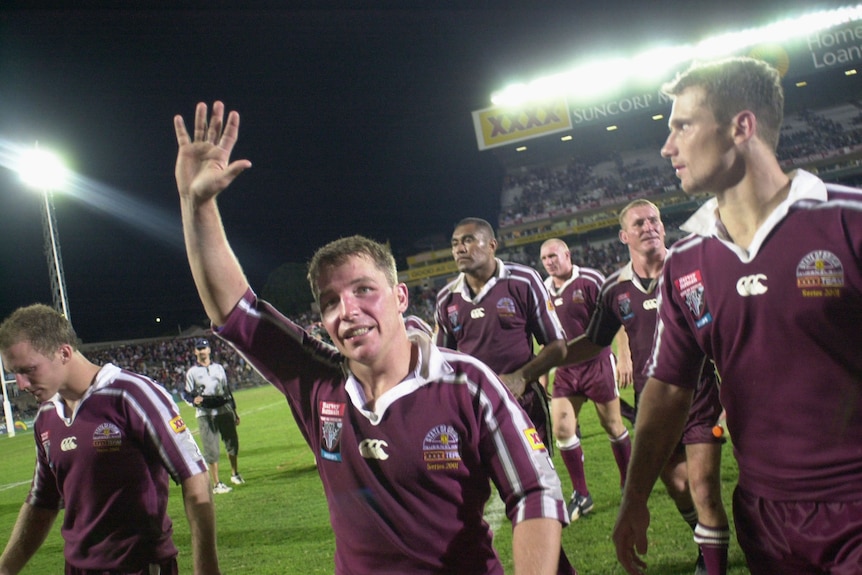 Paul Green in Origin jersey raising his hand.