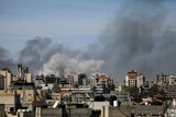 Smoke rises around apartment buildings