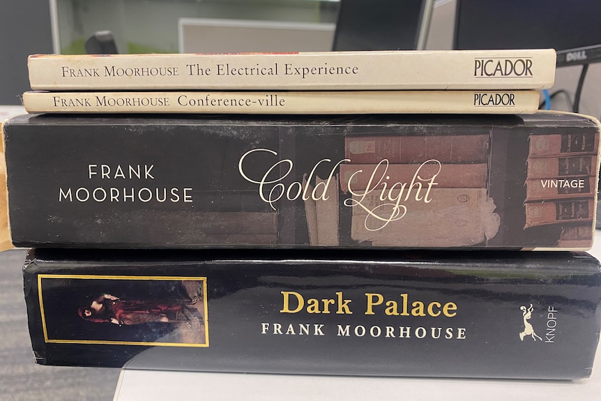 Four Frank Moorhouse books in a pile