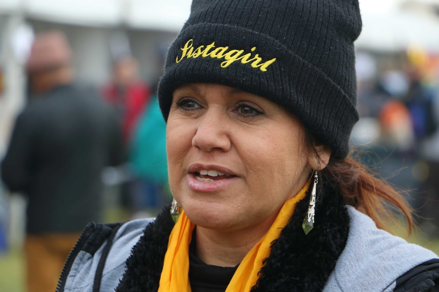 A close-up head shot of Della Rae Morrison wearing a black beanie.