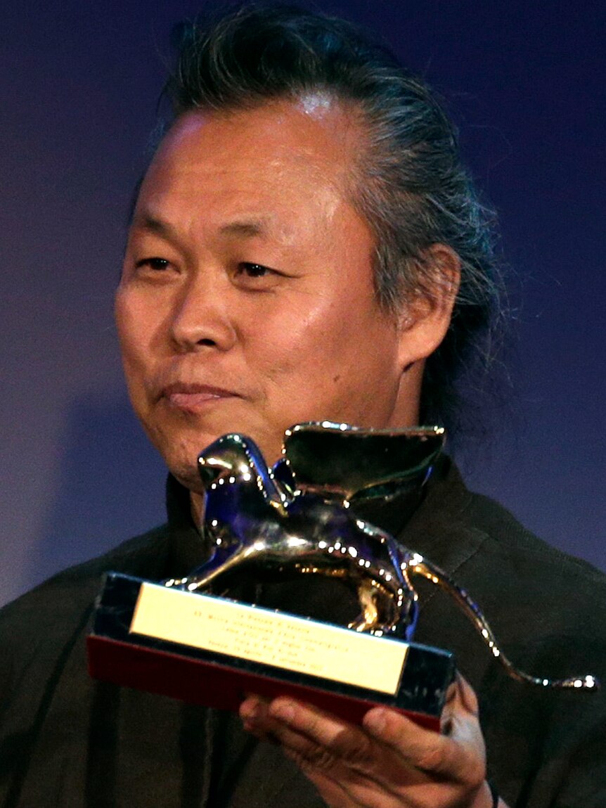South Korean director Kim Ki-duk holds the Golden Lion prize