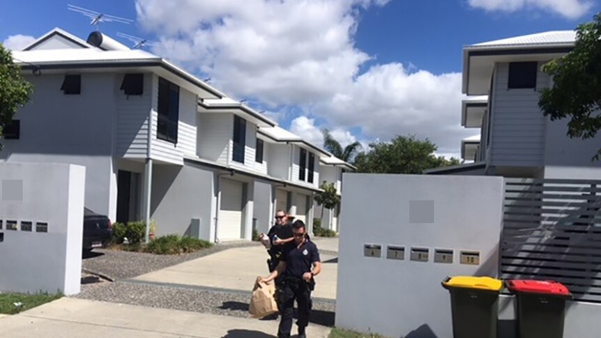 Police outside a modern townhouse complex