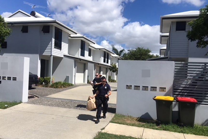 Police outside a modern townhouse complex