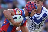 Kalyn Ponga runs with the football past the Bulldogs defence.