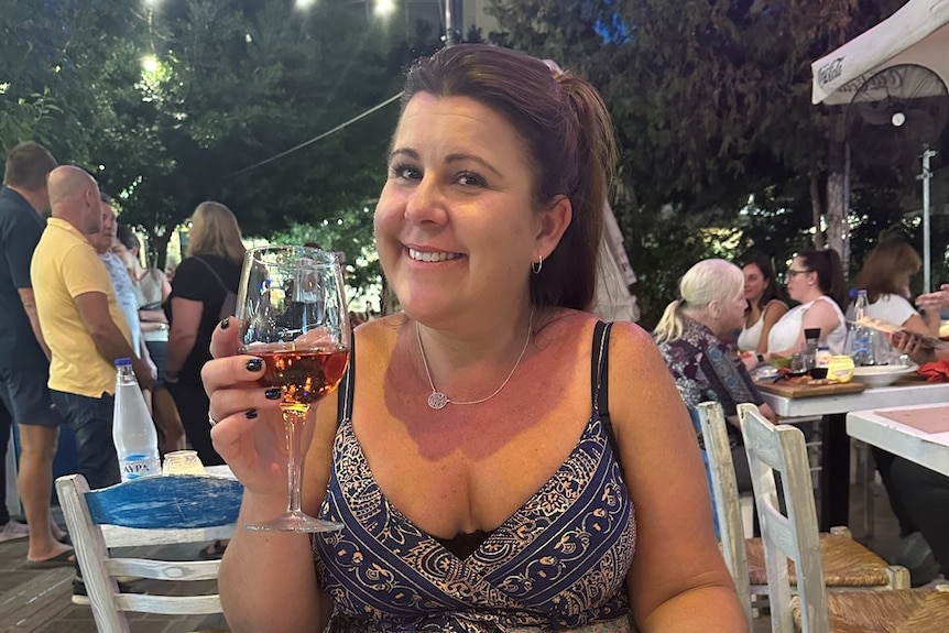 Woman enjoying a glass of wine at a restaurant 