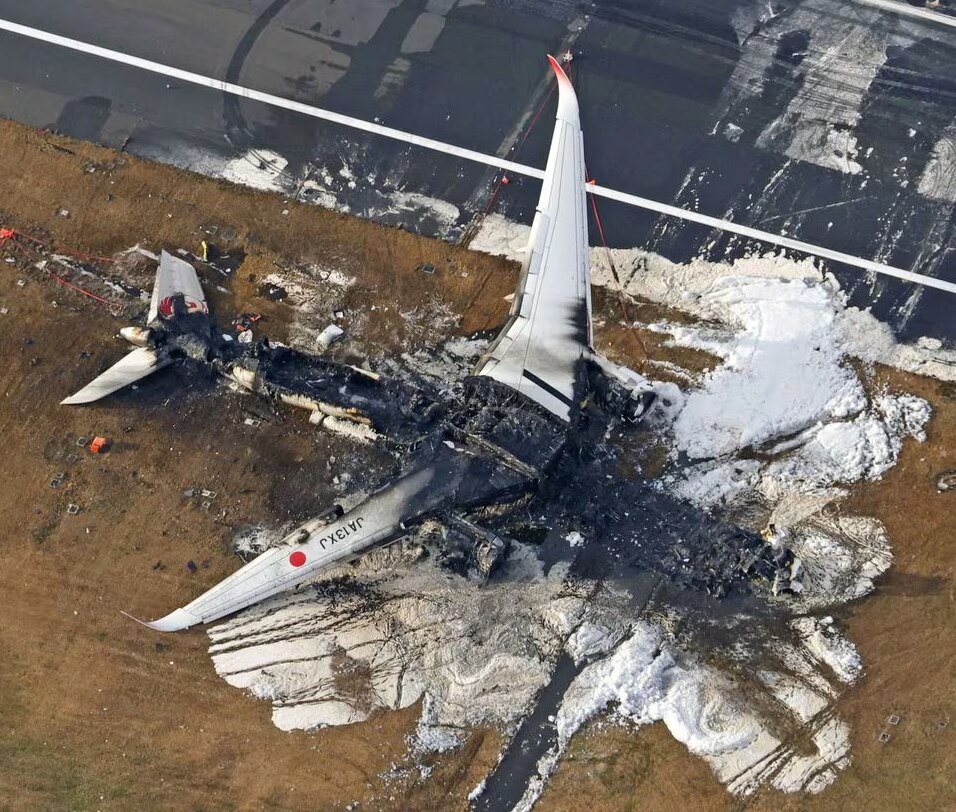 An aerial photo of a destroyed plane on the ground 