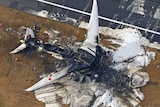 An aerial photo of a destroyed plane on the ground 