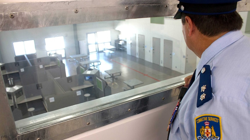 Prison guard looks into a new pod at Cessnock Gaol