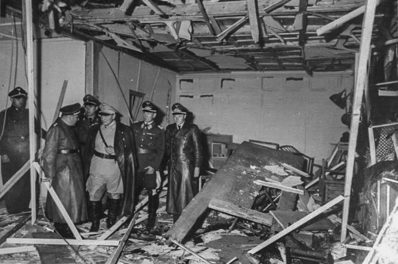 A black and white photo of a group of Nazis standing in a bombed out room