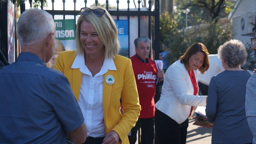 Nationals candidate for Gilmore Katrina Hodgkinson hands out voting material at a polling booth in Nowra.