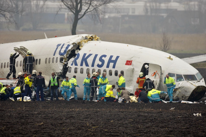 Rescue workers help passengers from a Turkish Airlines plane which crashed in Amsterdam.
