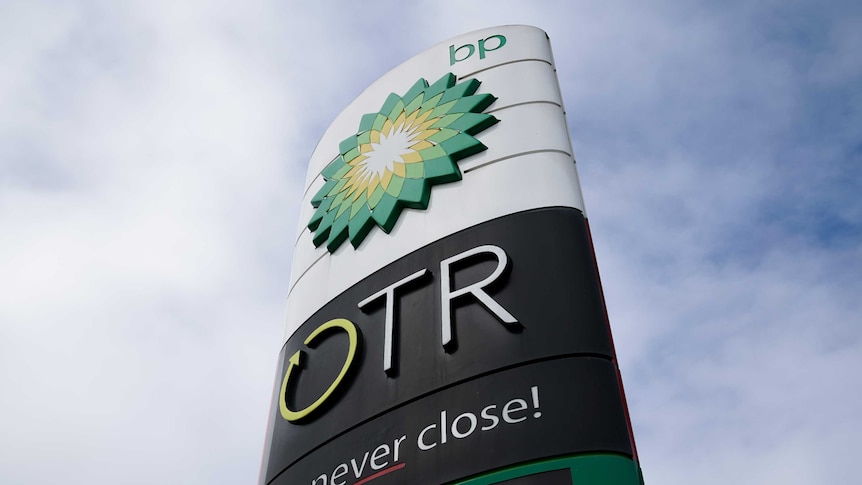 A sign outside a BP/On the Run petrol station. Blue cloudy sky is the background.