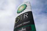 A sign outside a BP/On the Run petrol station. Blue cloudy sky is the background.