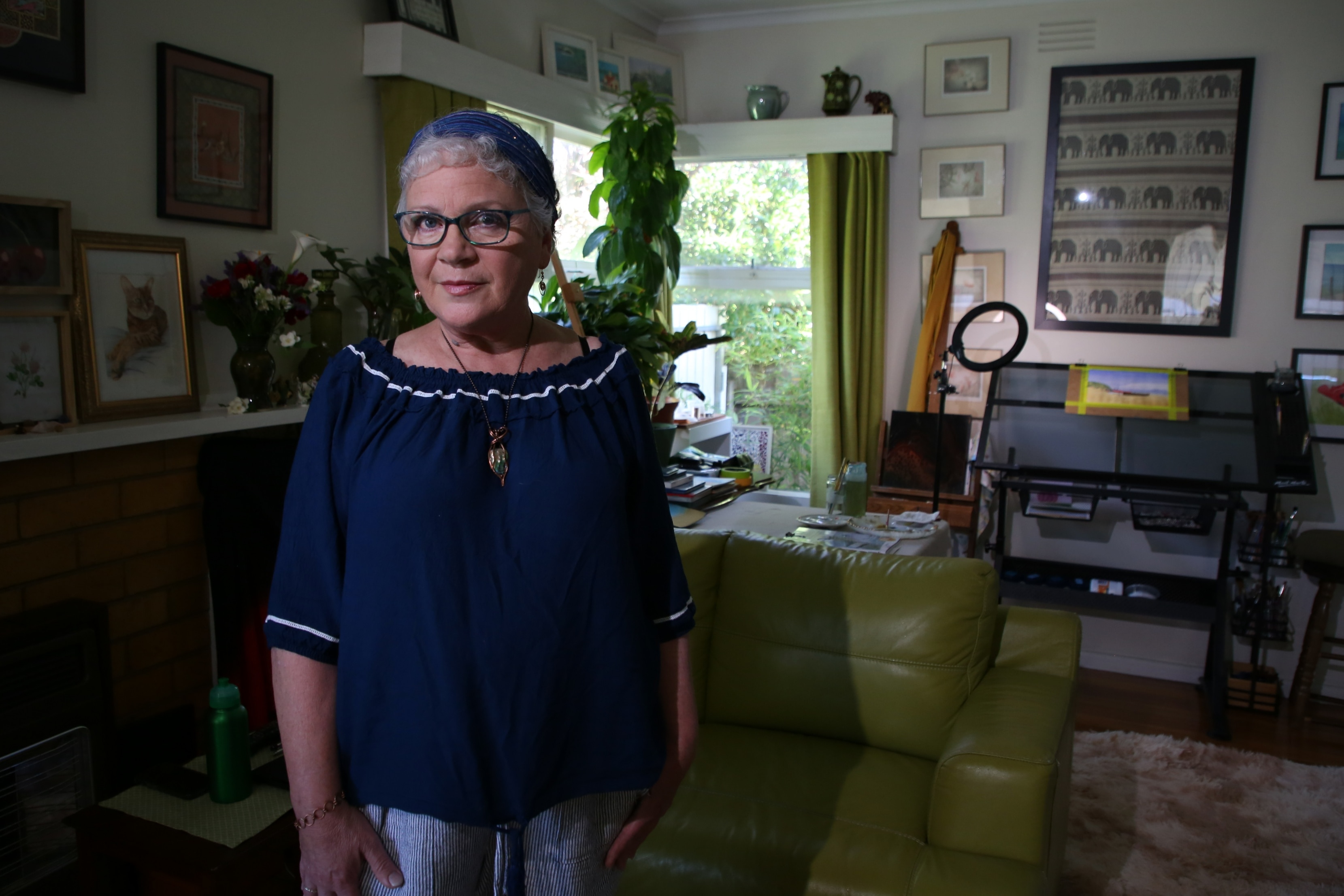 Tina Holt in her home decorated by paintings she has created herself.