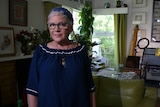 Tina Holt in her home decorated by paintings she has created herself.