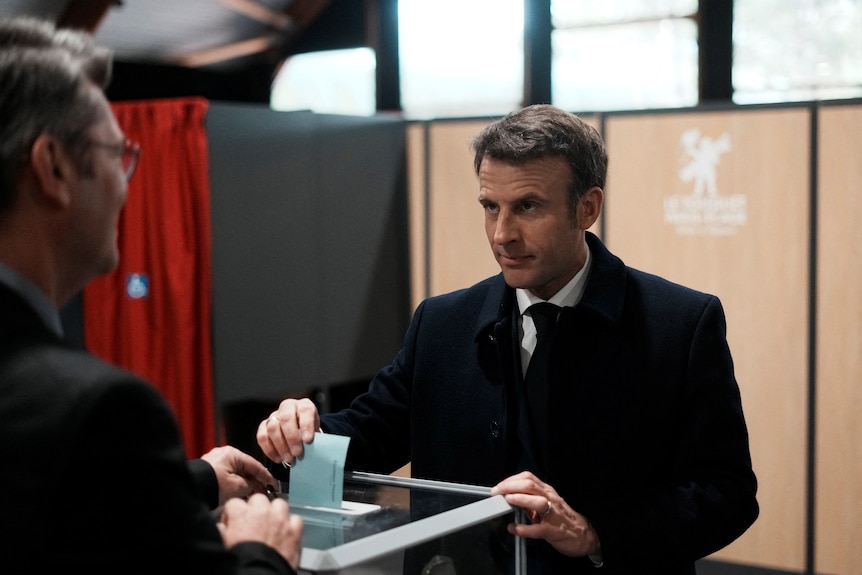 French President Macron votes at ballot box