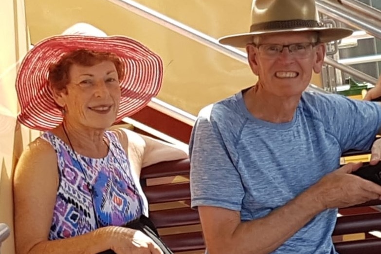 Barry and jess Roberts sitting beside each other, wearing hats, and smiling
