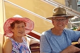 Barry and jess Roberts sitting beside each other, wearing hats, and smiling