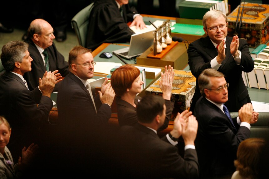 a group of government ministers clapping