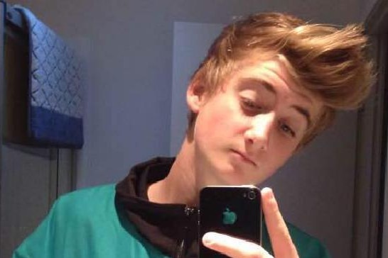 Ben Shaw, 15, takes a selfie in bathroom mirror in a jumper.