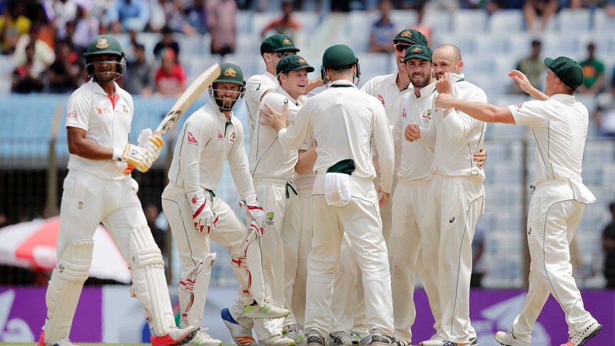 Bangladesh's Shakib Al Hasan trudges off as Australia's Nathan Lyon celebrates