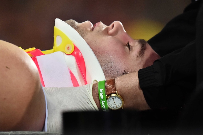 St Kilda's Paddy McCartin is stretchered off at Adelaide Oval after a head clash against Adelaide.