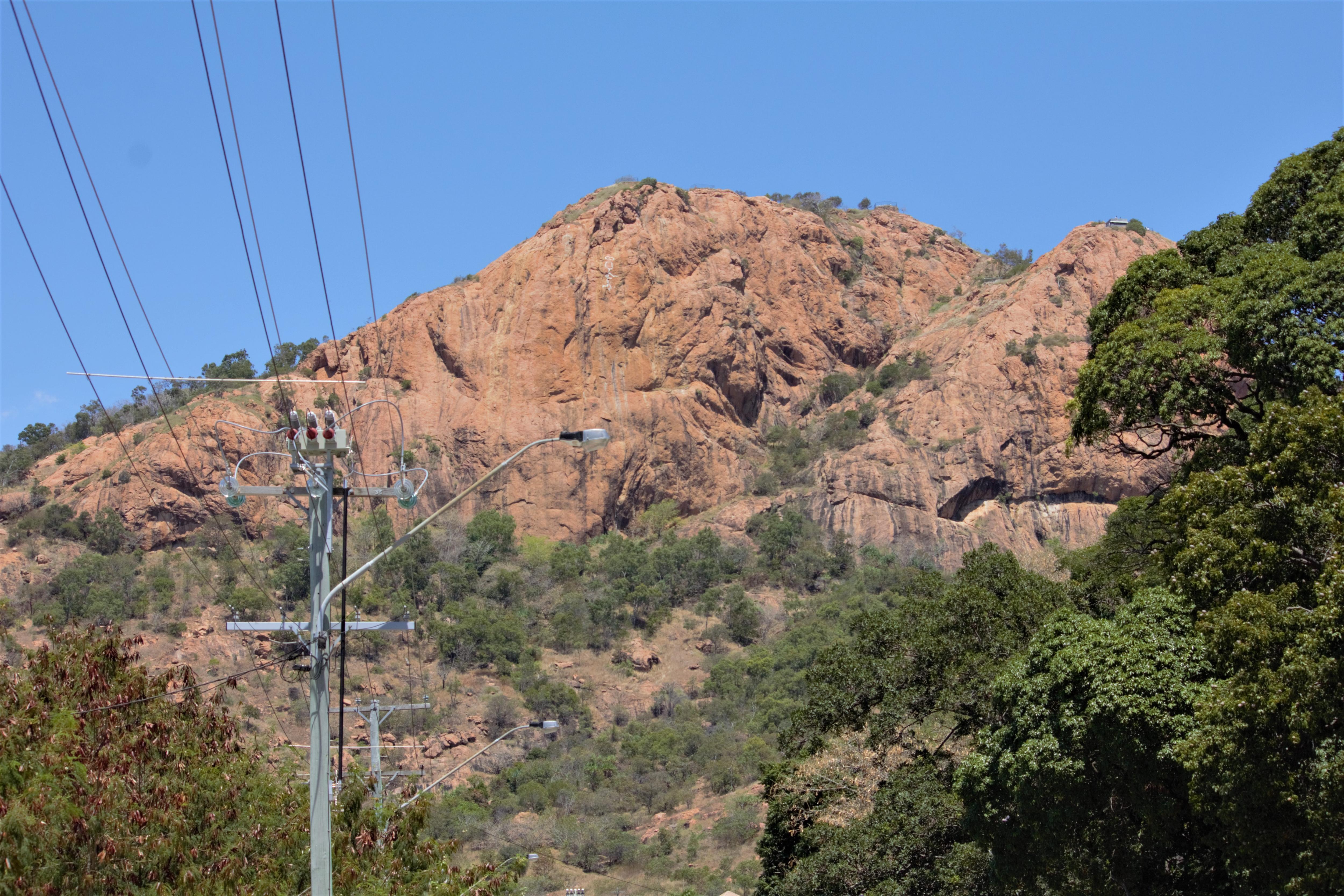 Townsville's Castle Hill with powerlines in the foreground.