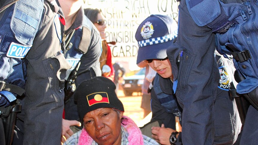 A traditional owner was carried away from the blockade to be arrested
