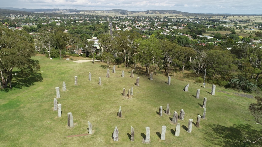 A drone shot of a stone circle with the town of Glen Innes in the background