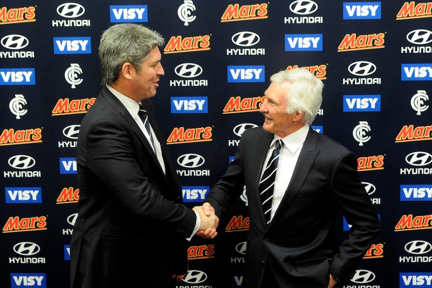 Mick Malthouse and Carlton club president, Stephen Kernahan, shake hands.