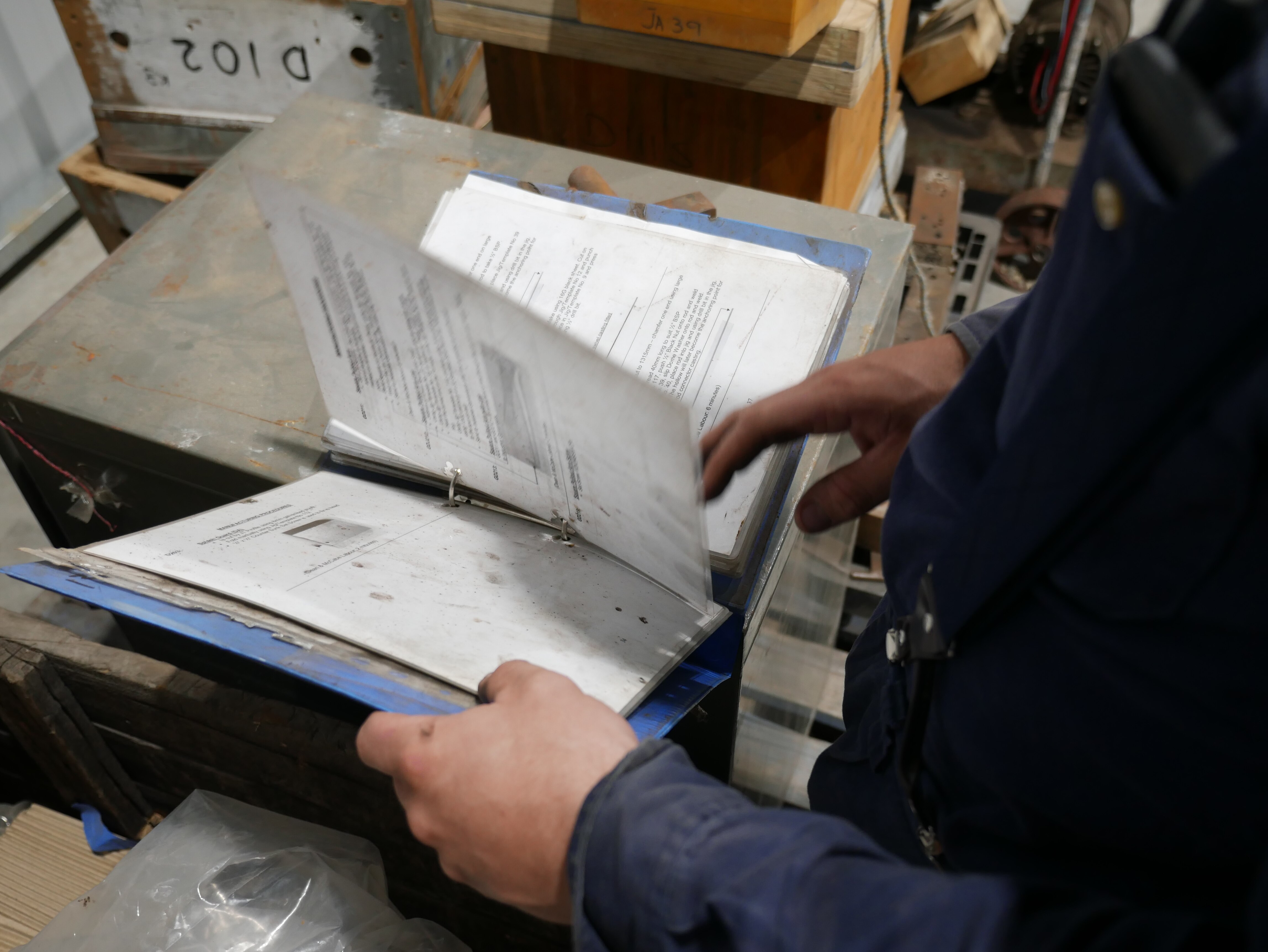 A man reading through a design manual. 