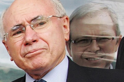 File photo: John Howard in front of a Kevin Rudd poster (Getty Images: Lisa Maree Williams)