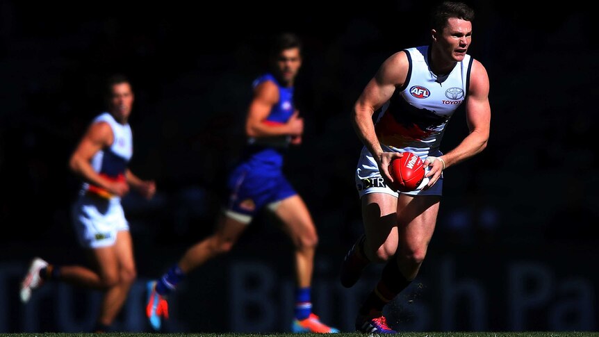The Crows' Patrick Dangerfield runs with the ball against the Western Bulldogs at Docklands.