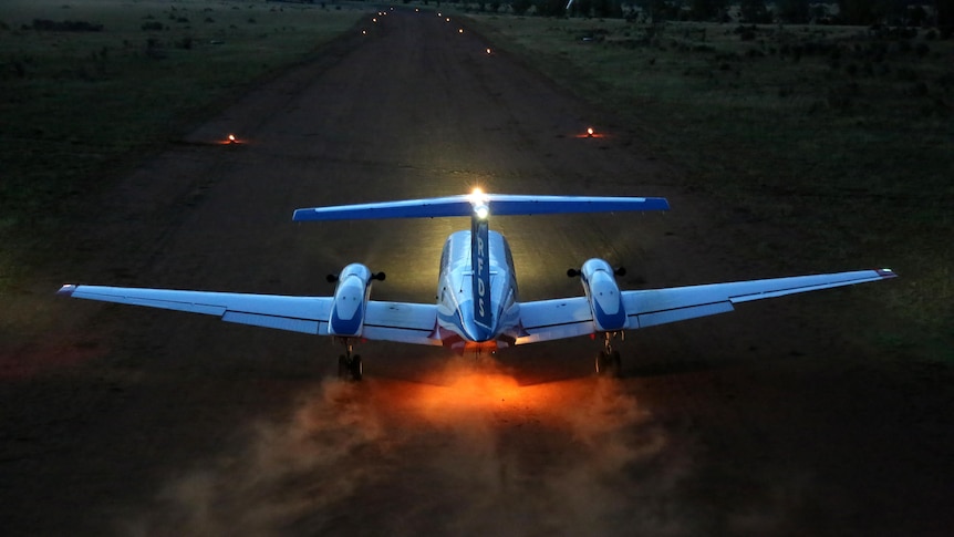 A Royal Flying Doctor plane comes into land on a dirt airstrip in regional Queensland