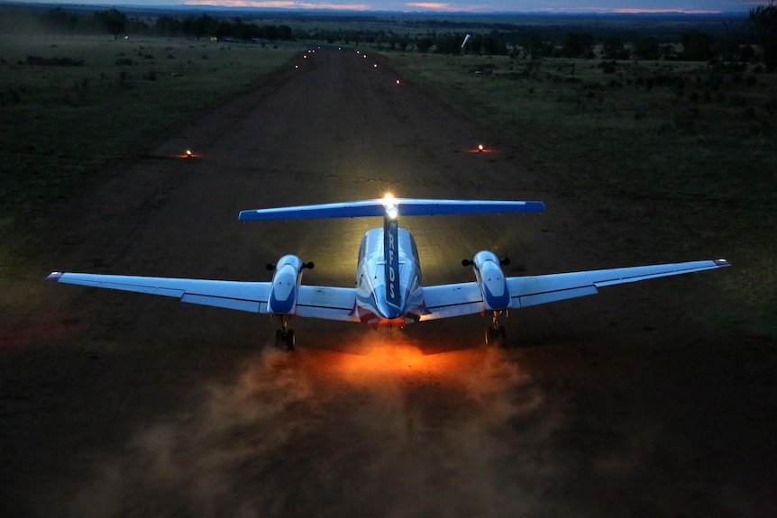 A Royal Flying Doctor plane comes into land on a dirt airstrip in regional Queensland