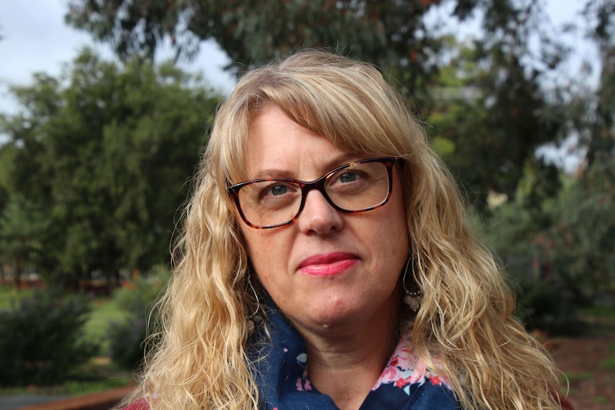 A woman in galsses in headshot