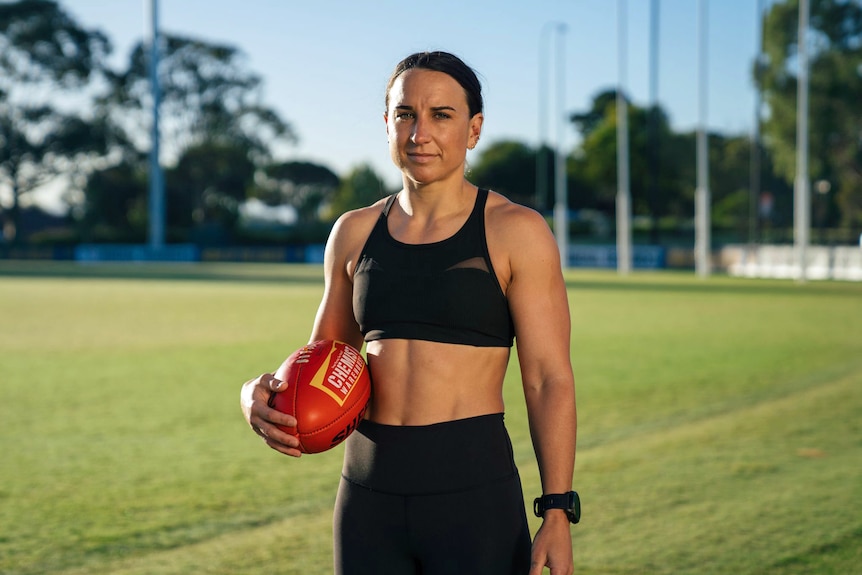 A woman holding a football.