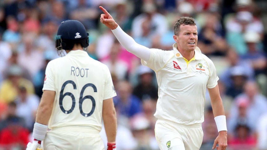Australia's Peter Siddle points his index finger after taking the wicket of England's Joe Root, seen from behind.