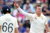Australia's Peter Siddle points his index finger after taking the wicket of England's Joe Root, seen from behind.