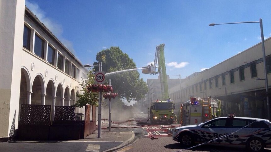 Fire crews hose down the fire in the Sydney Building.