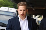 A man in a suit heading to court.